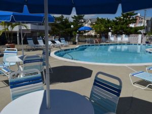 A close-up of a table and chair at the poolside.