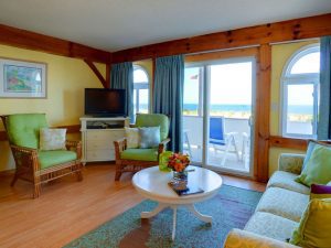 A full shot of a Living room interior with view of Dewey beach