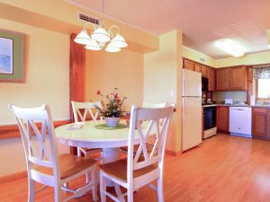 A full shot of Dining room and kitchen of a villa.
